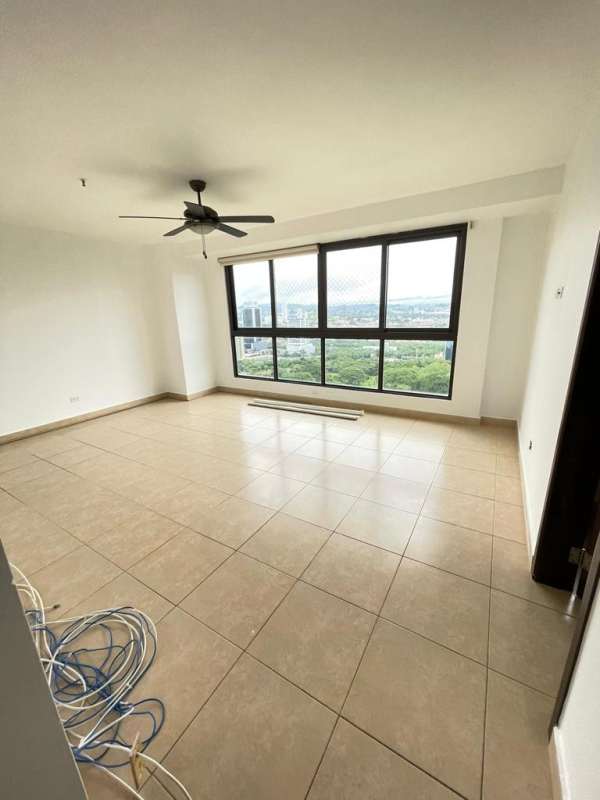 Bright living room with large windows overlooking ocean at Costa del Este PH Parque del Mar Panama