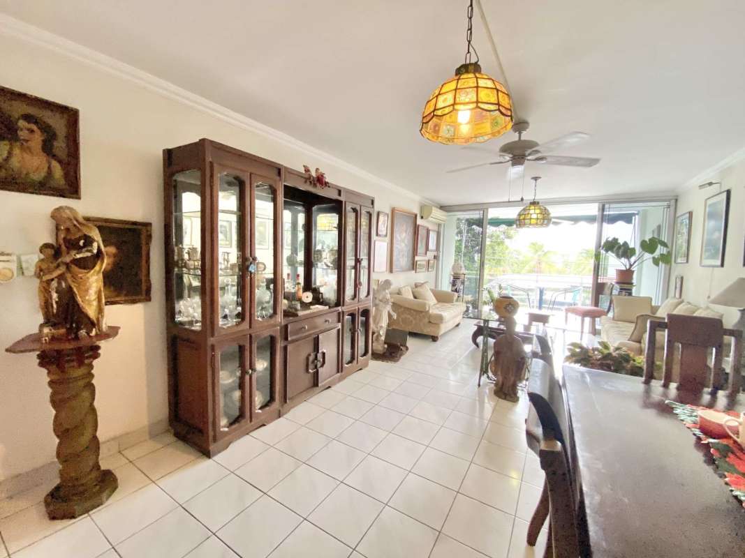 Open plan living and dining room with balcony access at PH Coconut Grove Coco del Mar Panama City