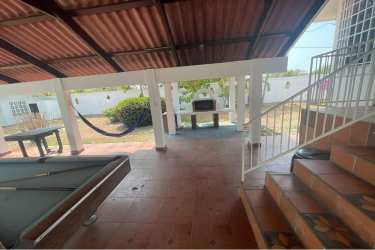 Two-story beach house front view with gardens in Punta Chame Panama for sale