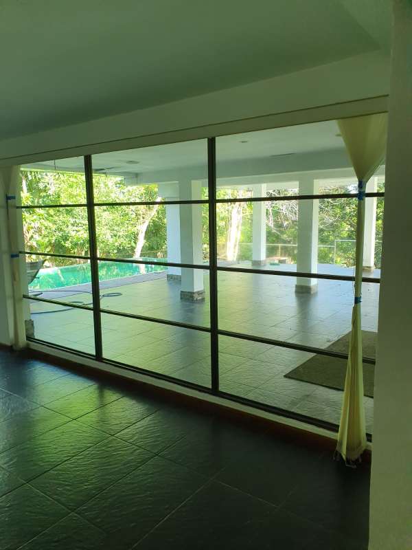 Sunroom or lounge area bright natural light overlooking garden Cardenas house Clayton Panama