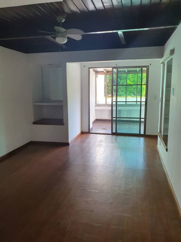 Large living room dark wood ceiling sliding door garden view Cardenas Clayton Panama