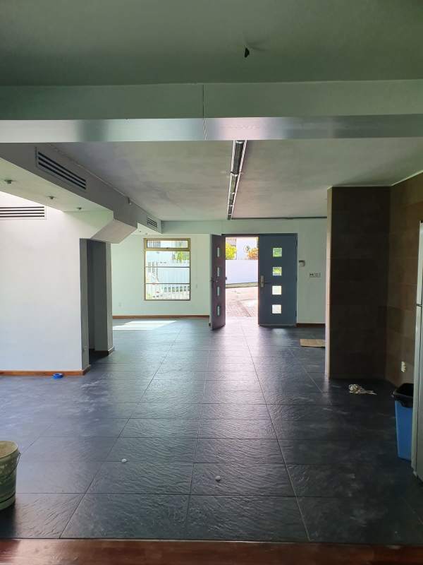 Spacious entrance hall slate floor large blue door modern design Clayton Panama