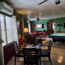 Spacious open terrace with seating area facing gardens at El Celaje estate Panama