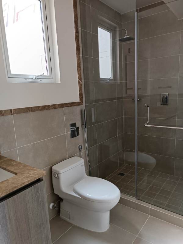 Open-plan living and dining with access to terrace overlooking golf course in Panama