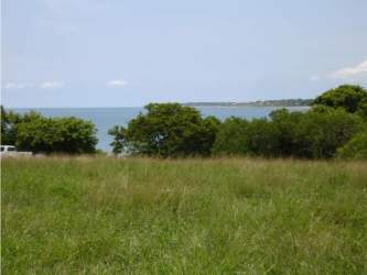 Wide green open field along oceanfront in Tonosí district Panama