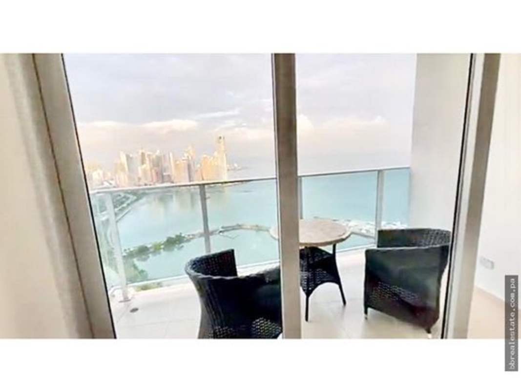 Dining area adjacent to balcony with ocean skyline view in PH White Tower Panama