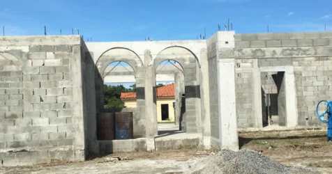 Concrete walls and arched doorways of home under construction in gated community Panama