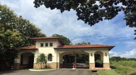 Mediterranean inspired gateway with arches and tile roof at Hacienda Pacifica San Carlos