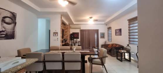 Spacious kitchen with granite island, dark wood cabinets, and appliances in Hacienda Pacifica San José Panama