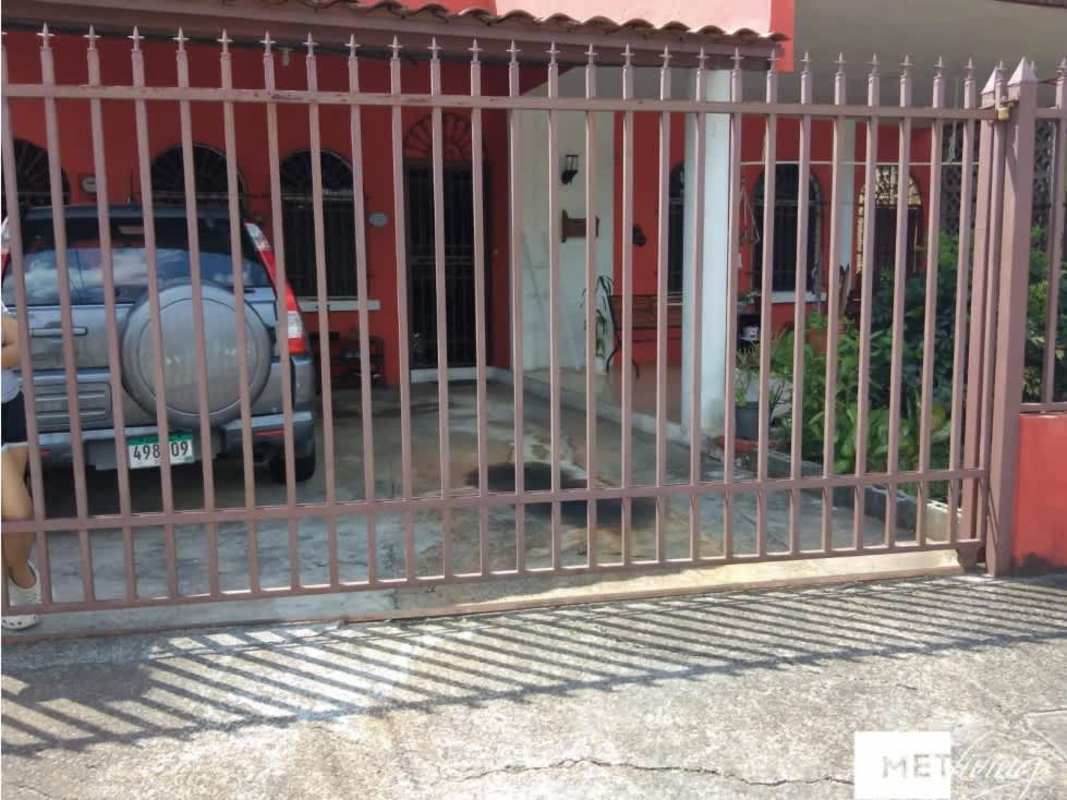 Spacious living room with wood ceiling, large windows and entertainment center in Bethania house for sale