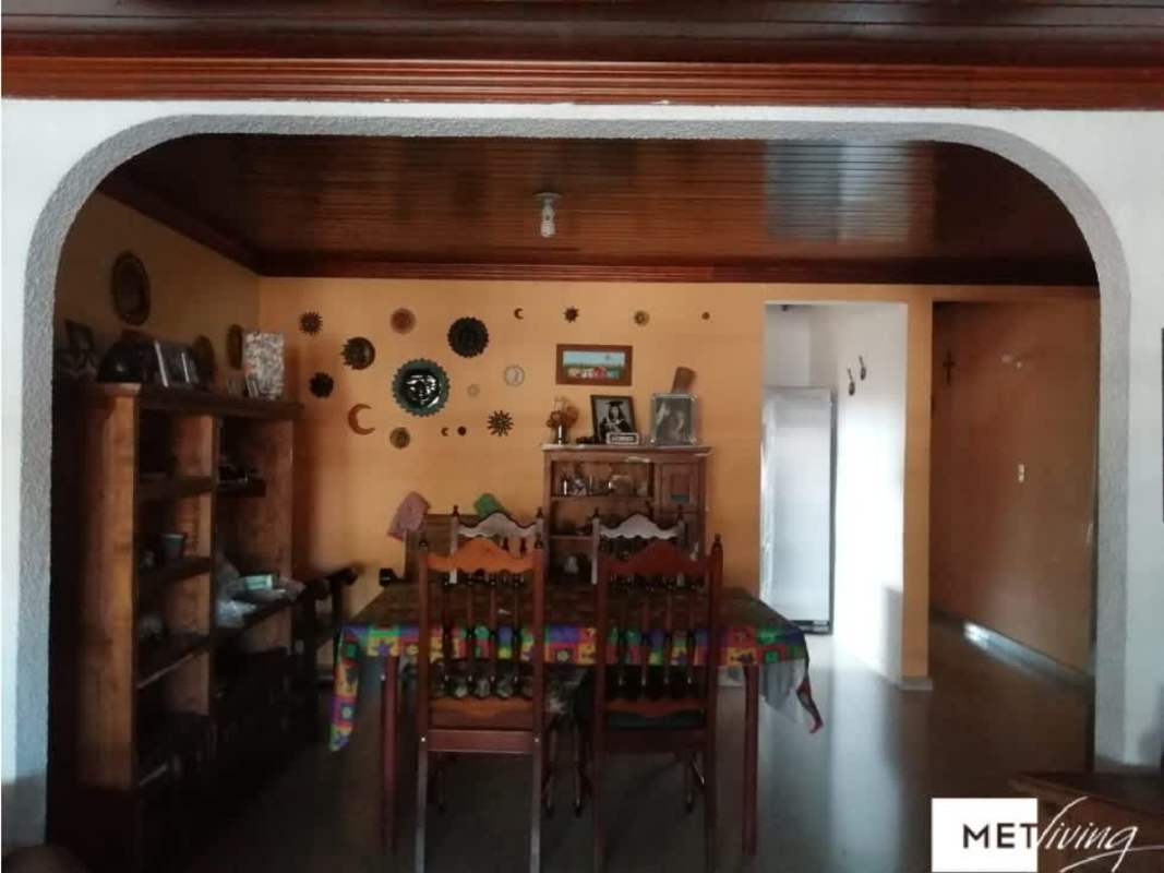 Colorful porch with swing and plants, orange accents, in Bethania Panama home for sale