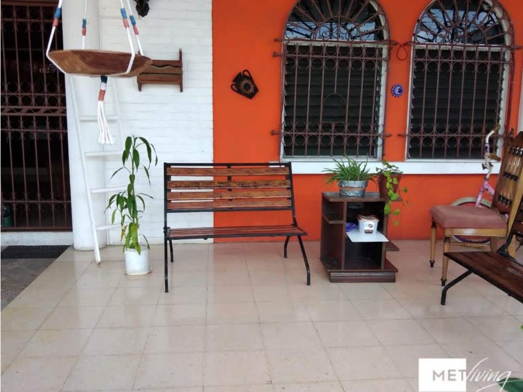 Single story Panama home with gated entrance, red accents and tiny front garden in Bethania for sale