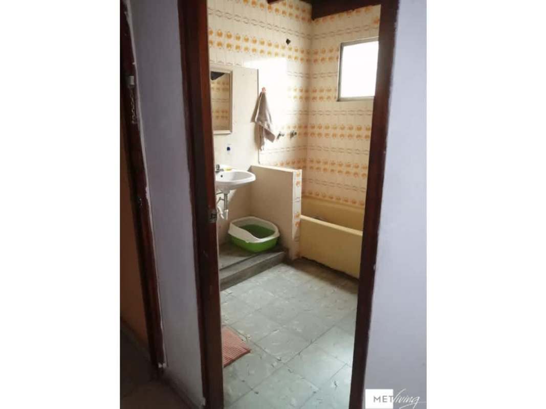 Rustic dining room with wooden furniture and wall art in Bethania Panama house for sale