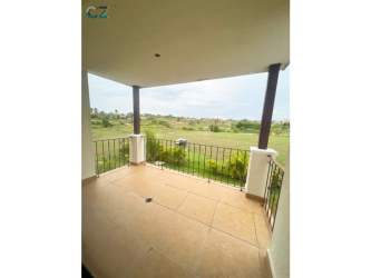 Covered balcony with green golf course and partial ocean view in Vista Mar Resort Panama