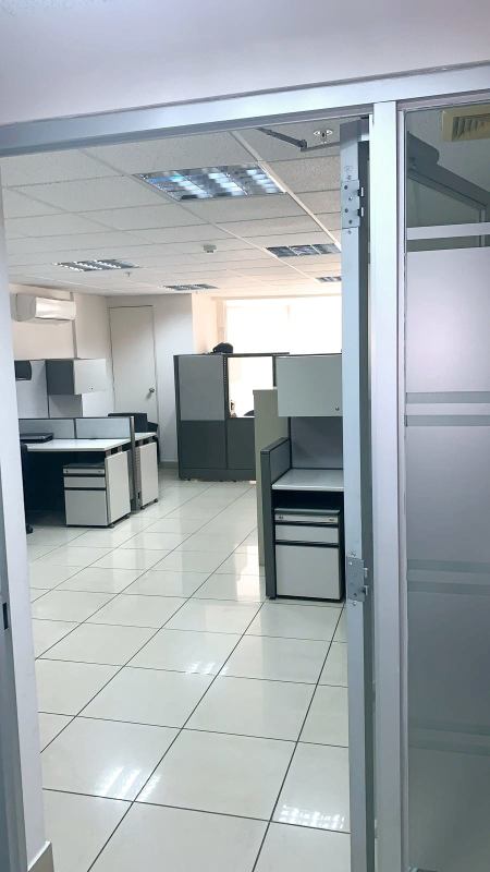 Modern small office with blue accent wall and glass partitions PH Centro Empresarial Mar del Sur Panama