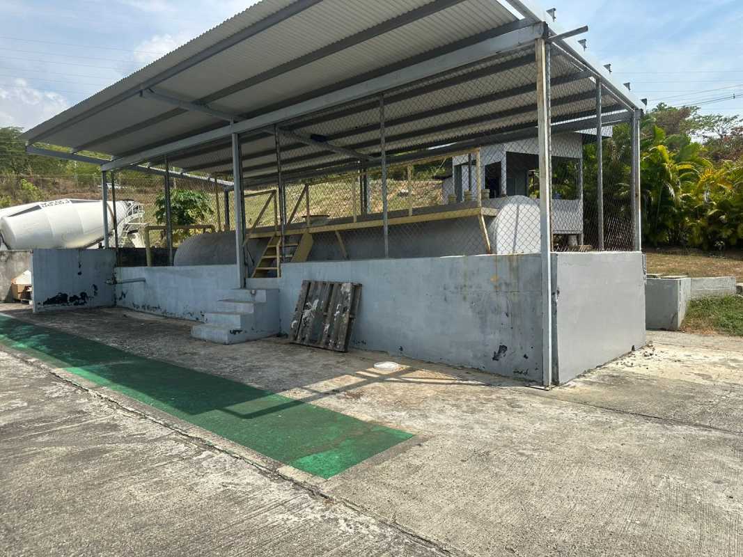 Industrial outdoor fuel or storage station with canopy and perimeter fence in Panama