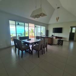 Resort-style swimming pool surrounded by palm trees and gardens at Bijao Quarry Heights