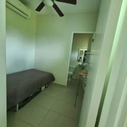 Master bedroom with terrace access, ocean view, ceiling fan, and AC in Bijao Quarry Heights