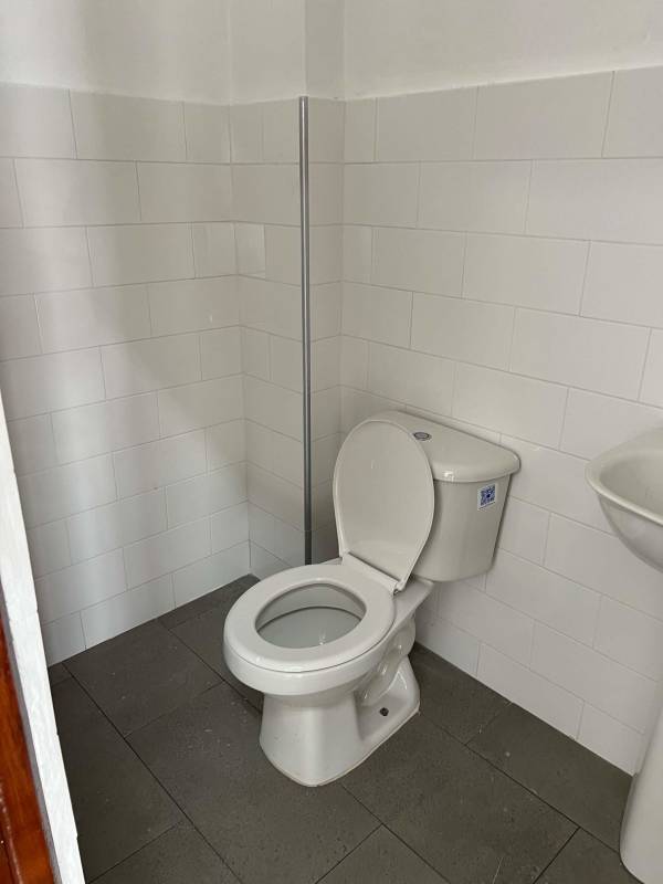 Modern commercial building featuring metal shutters and ample parking on Via España Panama City