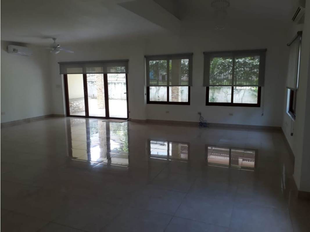 Contemporary foyer with black door, iron rail stair, tile floor in Panama house for sale