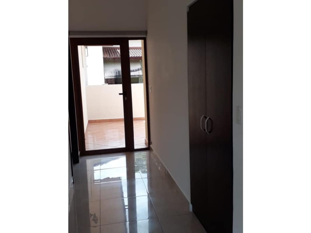 Bright large living area with tile floors, windows to garden in Senderos Camino Clayton Panama house