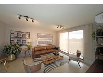 Modern living room with sofa, TV, dining table, balcony access in PH Madeira Woodlands Panama Pacifico