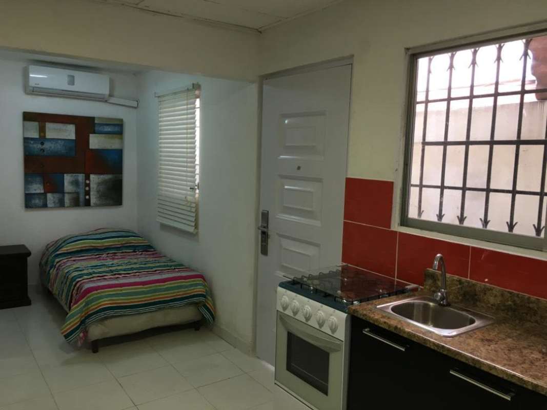 Compact studio with bed, kitchenette area, security bars window in Hato Pintado apartment Panama City