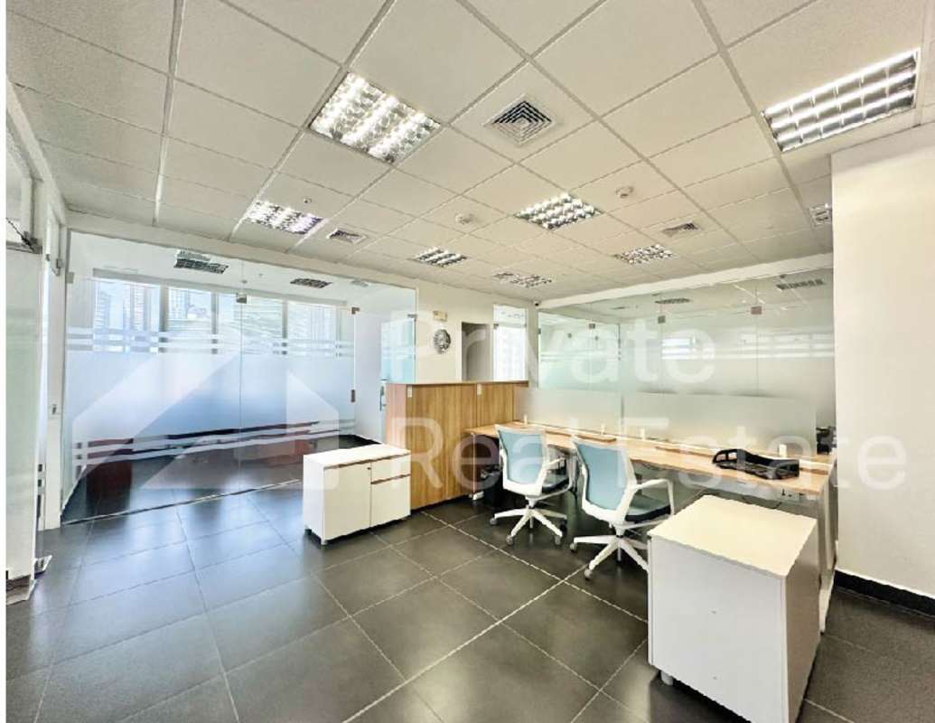 Open workspace with desks and chairs in Costa del Este Tower Centenario office