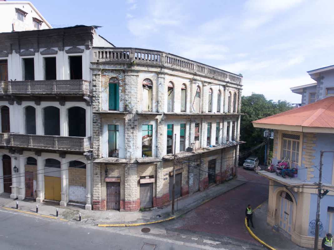 Abandoned colonial facade with arched windows three-story on historic corner in Casco Viejo Panama