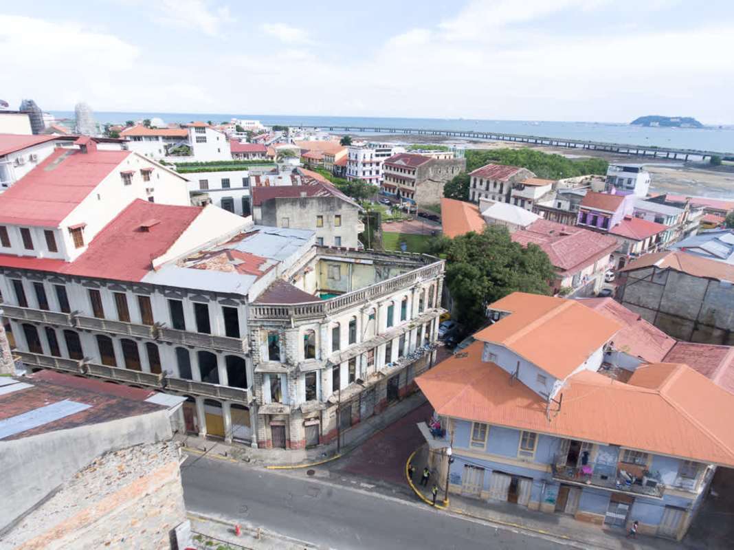 Aerial view of historic Casco Viejo with red tile roofs and ocean nearby