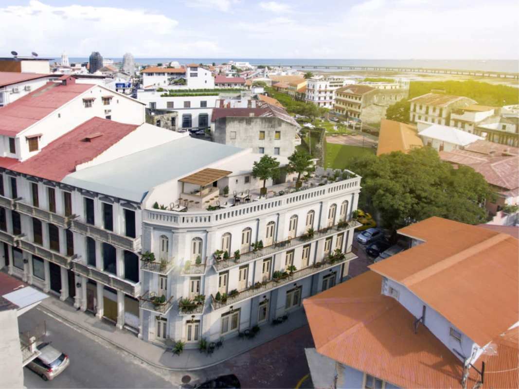 Aerial of colonial historic multi-story building with rooftop terrace near Panama waterfront