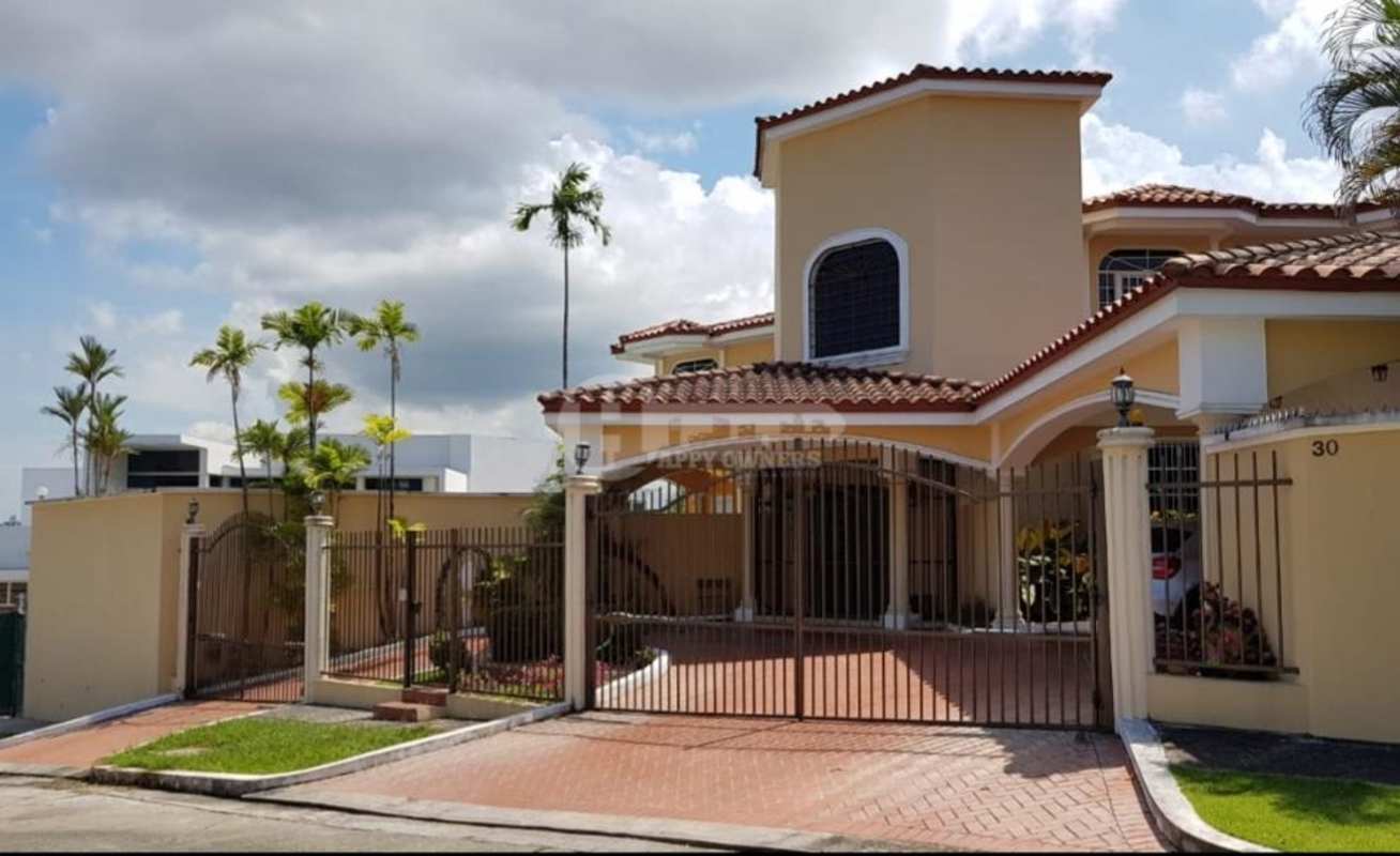 Covered carport with brick driveway, arch details and lush garden in luxury mansion Hato Pintado Panama