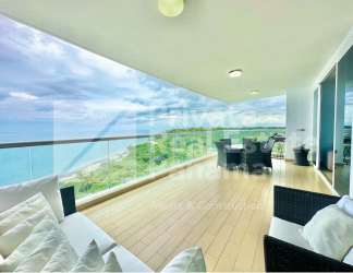 Furnished living room with sea views, split AC, tile floors in beachfront condo
