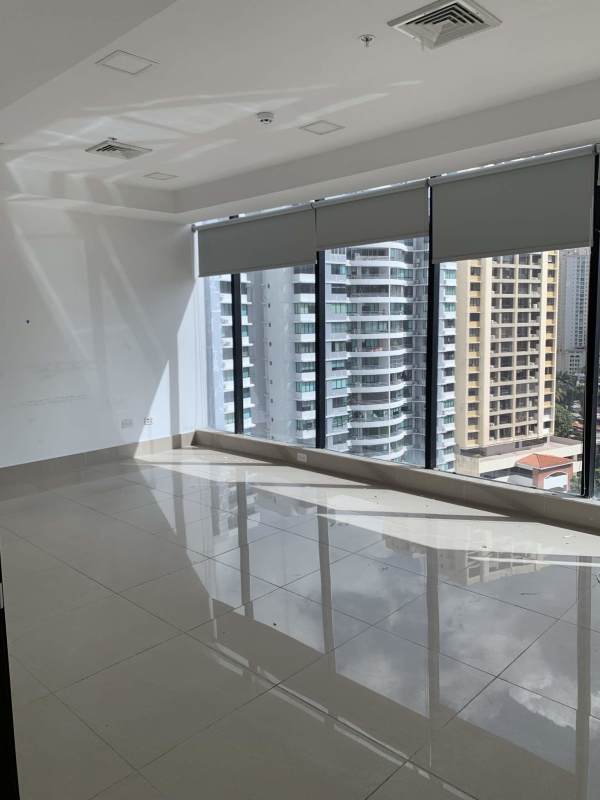 Large empty office with tall windows and city skyline views at RBS Tower Punta Paitilla Panama