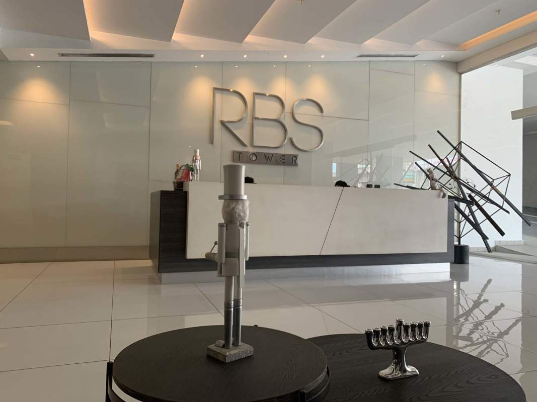Modern reception lobby interior with marble and corporate signage at RBS Tower Panama City
