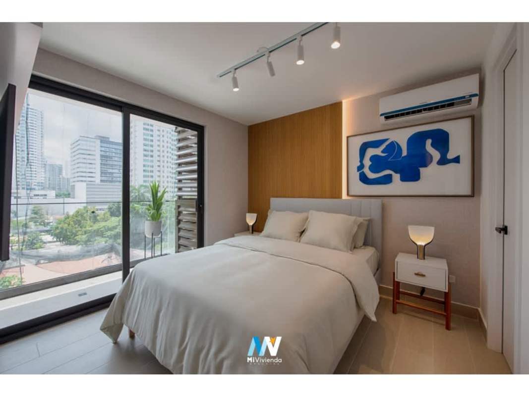 Skyline view rooftop infinity pool with lounge area at PH Be Living San Francisco Panama