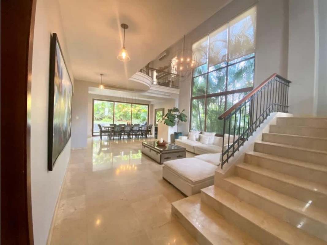 Spacious living room with double height windows overlooking gardens in luxury Clayton residence