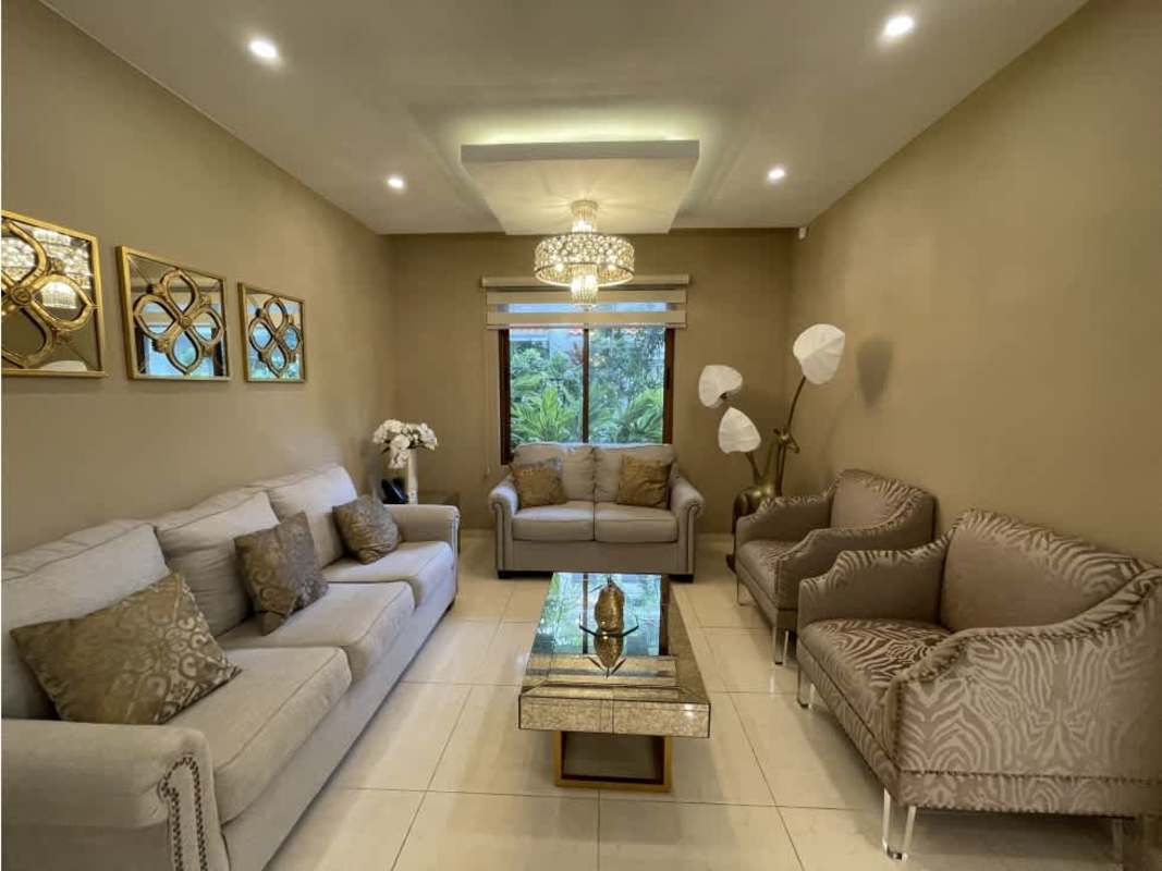 Elegant dining space with large windows, contemporary chandelier and garden view in PH Los Senderos Clayton