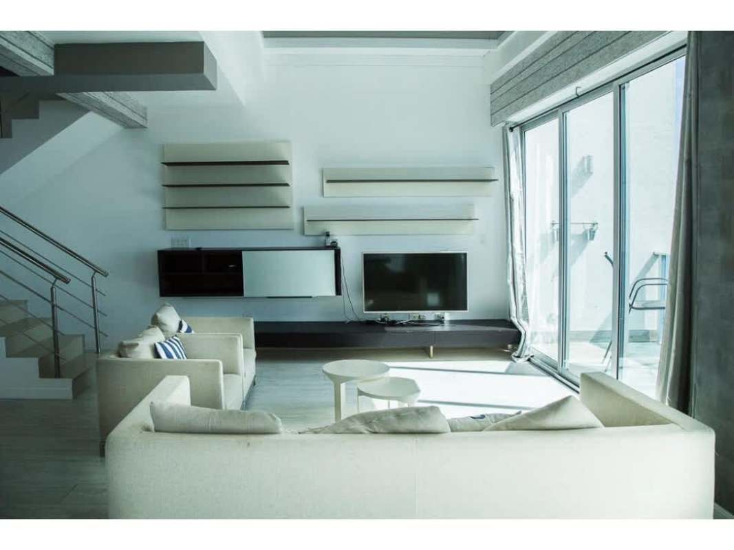 Floor-to-ceiling glass master bedroom with balcony and sea views at Icon Tower Coco del Mar