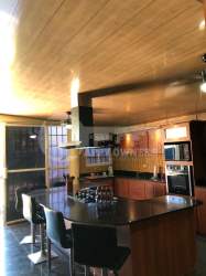 Single-story house with tiled roof, porch, gated driveway in Los Perales Chitré Panama