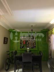 Contemporary kitchen with large island, granite counters, wood cabinets in Chitré house