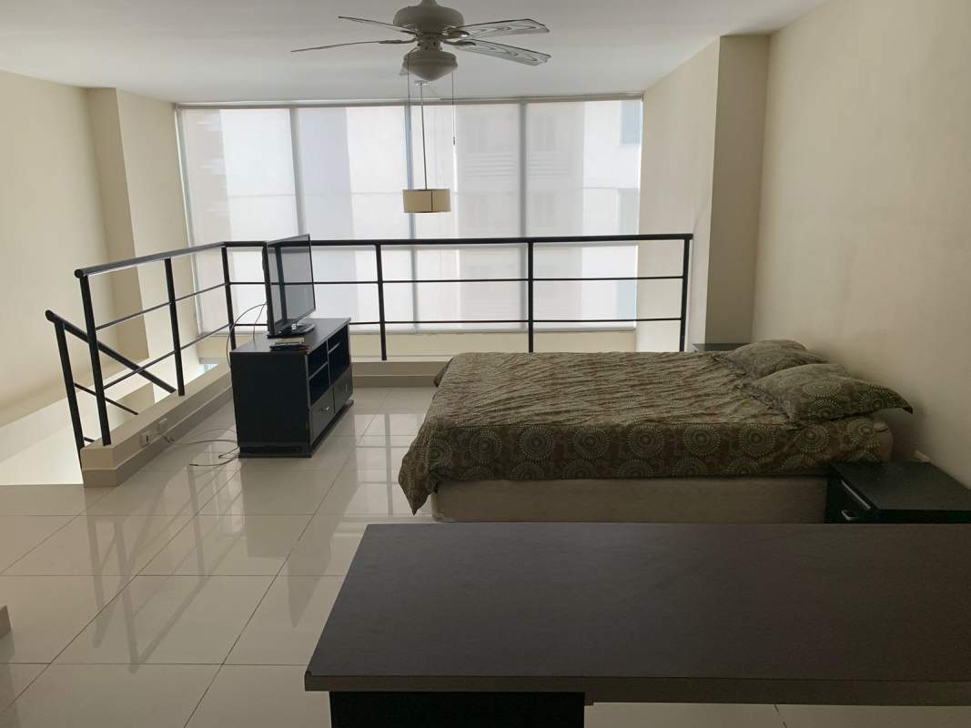 Open plan dining and modern kitchen with stainless steel appliances at PH Vitro Loft Panama