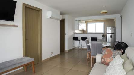 Modern living & dining space with natural light, ocean view balcony access in El Palmar Residences San Carlos