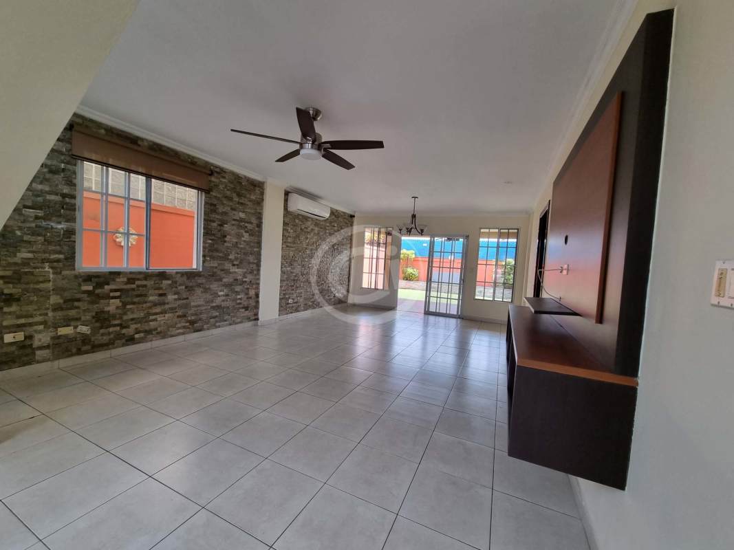 Large tiled terrace with covered lounge space, stone bar and BBQ corner at PH Castel Novo Chanis Panama