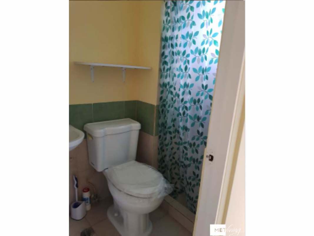 Bathroom with vessel sink, shower curtain, toilet in Los Pueblos Garden apartment Panama