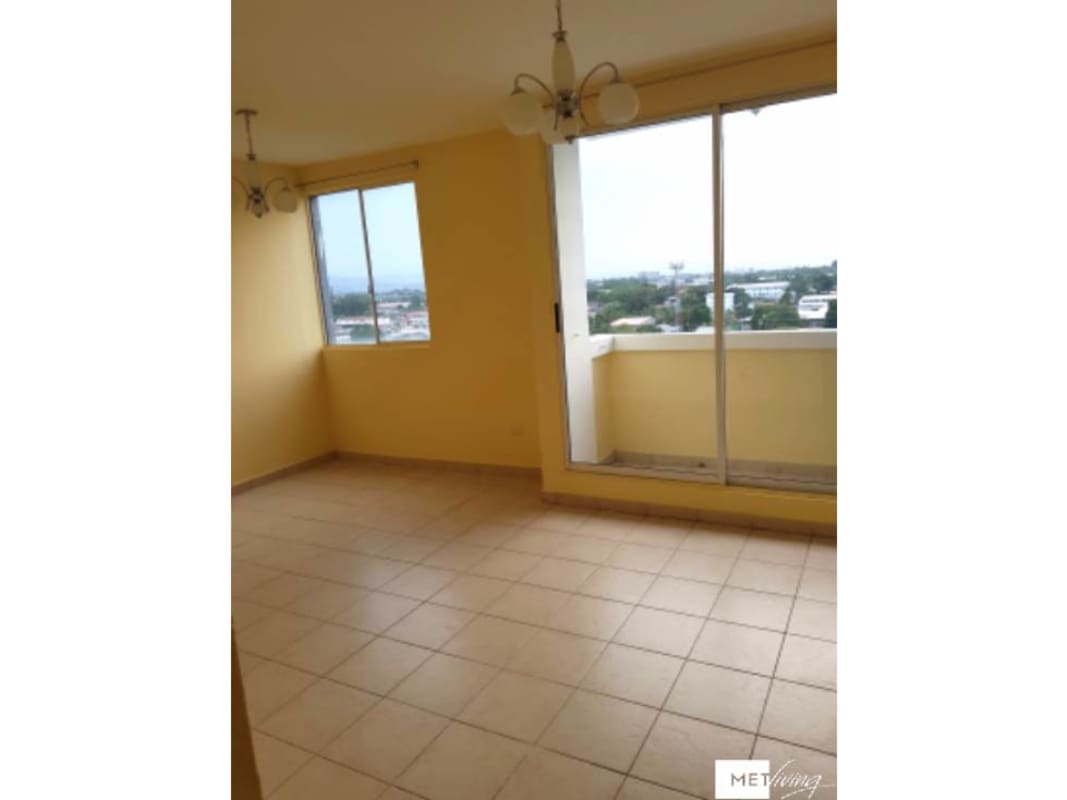 Living room with sliding glass door to balcony Los Pueblos Garden apartment Juan Díaz Panama