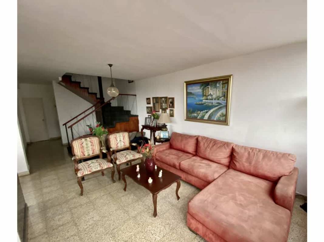 Bright living room with sectional pink sofa art stairs PH Bahia Azul Carrasquilla