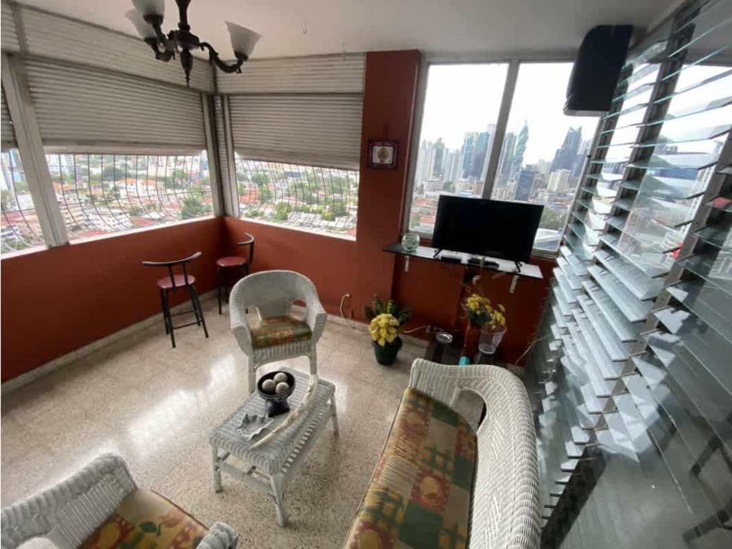 Spacious enclosed balcony sunroom city skyline wicker furniture PH Bahia Azul