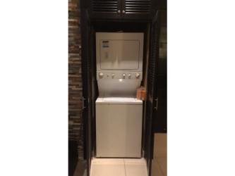 Covered terrace with dining furniture, fans, tropical vegetation at Playa Blanca Resort Panama