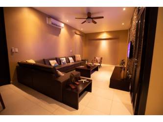 In-unit stacked washer and dryer laundry closet with storage in Playa Blanca Panama